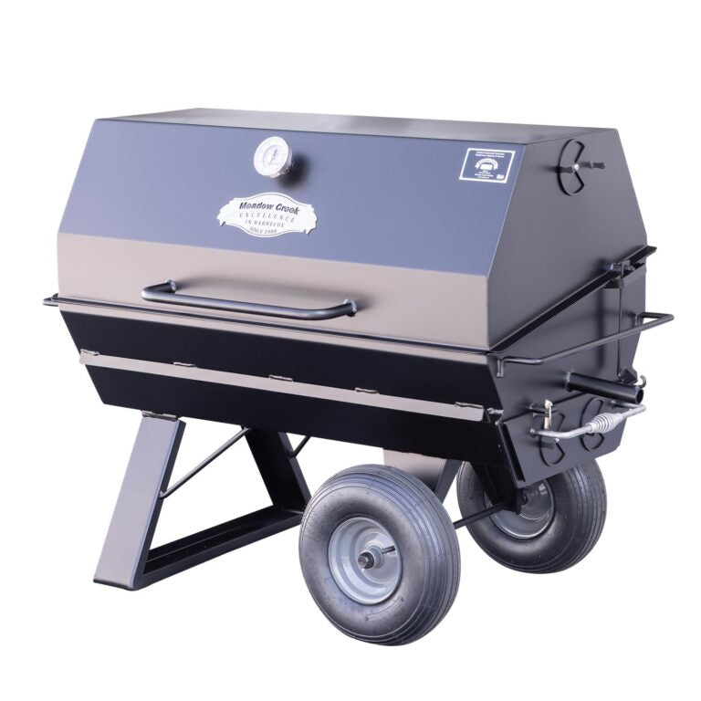 A side view of the Meadow Creek PR42 pig roaster with the lid closed, displaying the sleek black exterior and sturdy construction.