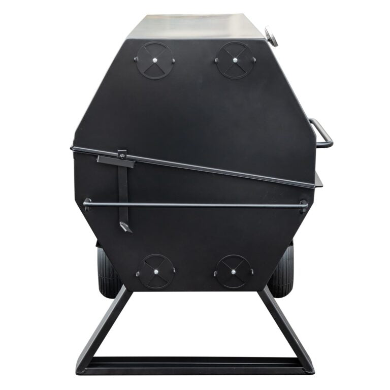 Side profile of a closed Meadow Creek pig roaster, showing the black metal body with circular vents and sturdy legs.