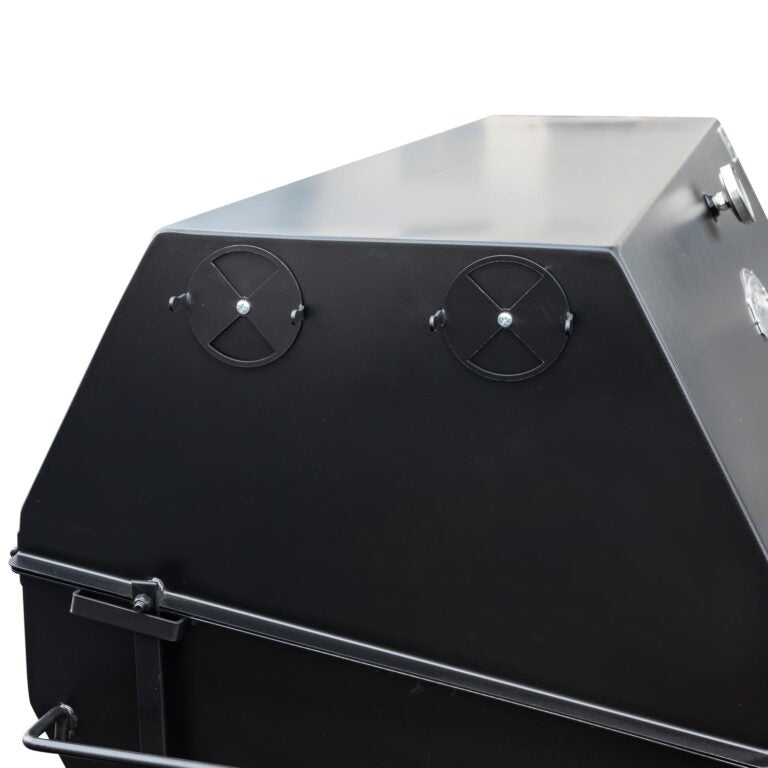 Close-up of the black metal vents on the side of a Meadow Creek pig roaster, showing two adjustable circular vents.