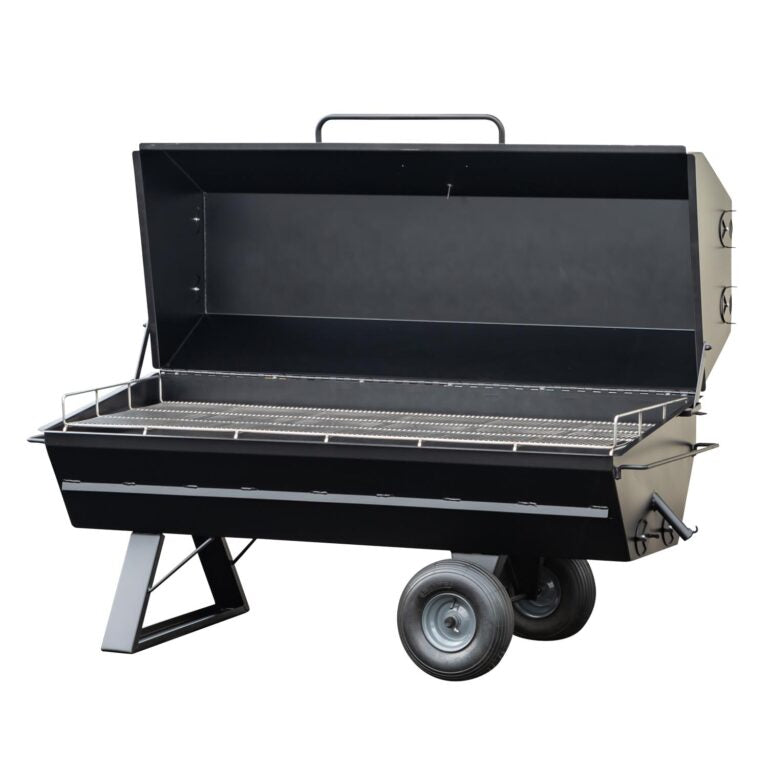 An open Meadow Creek pig roaster with a large stainless steel grilling grate, black metal body, and two large wheels for mobility.