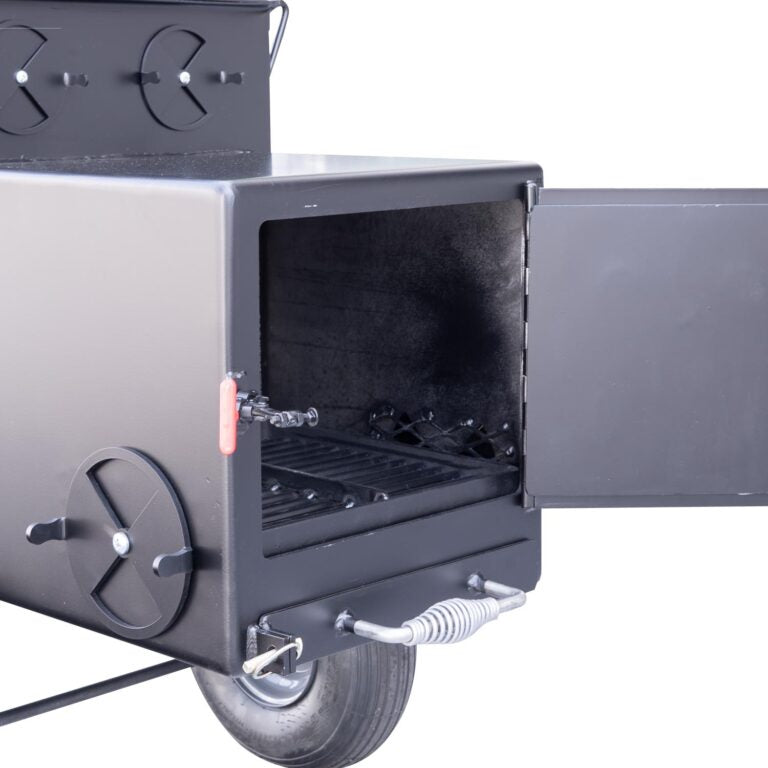 Side view of a Meadow Creek smoker with the firebox door open. The smoker features an adjustable air vent on the door, a red handle for controlling airflow, and large wheels for easy transportation.