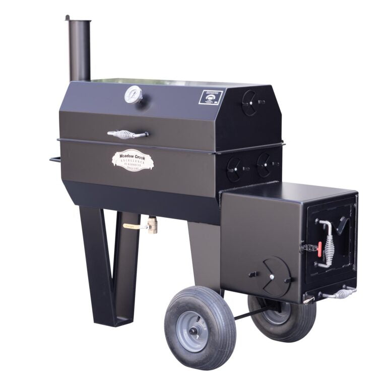 Full side view of a Meadow Creek offset smoker with the lid closed. The smoker features a built-in thermometer, air vents, large wheels, and a spring handle on the firebox door for safe operation.
