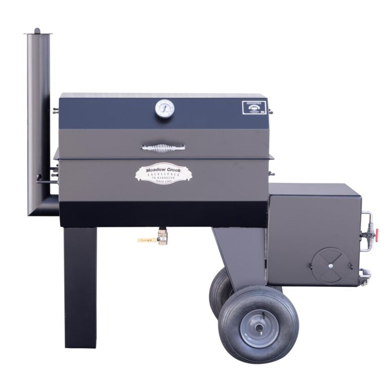 Front view of the Meadow Creek SQ36 offset smoker with the lid closed. It shows the main body, large wheels, and a side firebox with a vent.