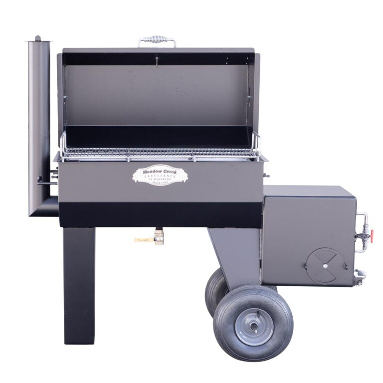 Front view of the Meadow Creek SQ36 offset smoker with the lid open, displaying the spacious cooking area. The smoker has a prominent logo plate and sturdy construction.