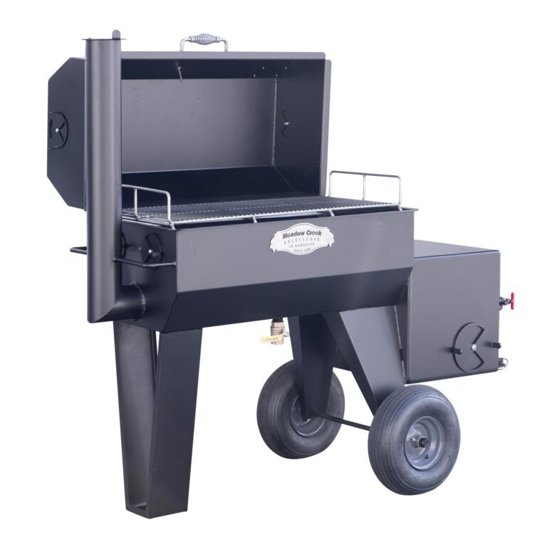 Full view of the Meadow Creek SQ36 offset smoker with the lid open, showing the cooking grate and interior. The smoker is black with sturdy legs and two large wheels for mobility.
