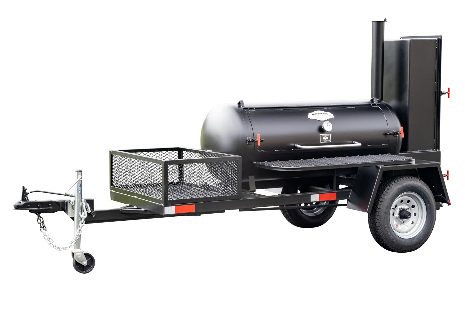 Full view of a Meadow Creek BBQ smoker trailer with a closed smoking chamber and a front utility basket, mounted on a sturdy black frame.