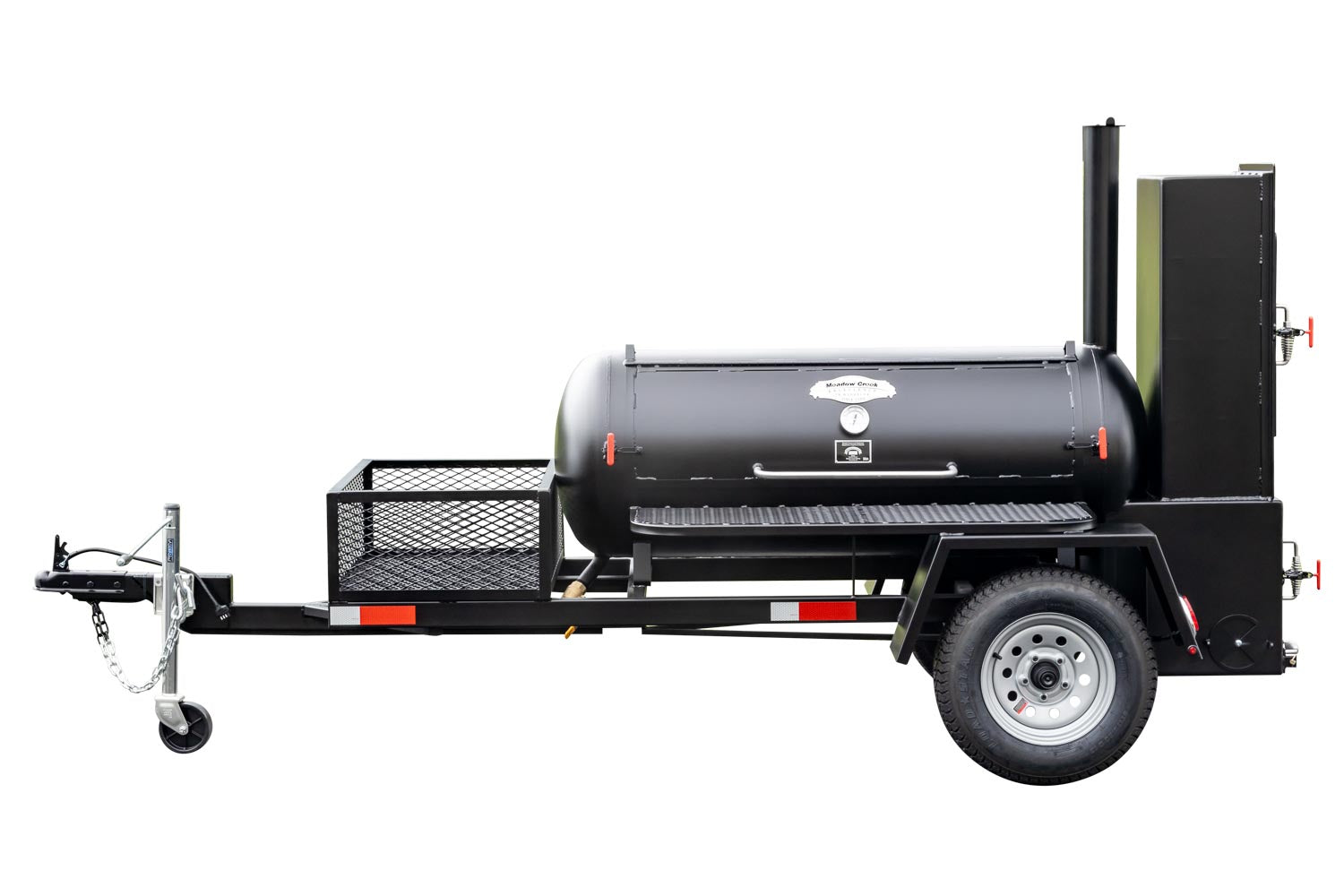 Full view of a Meadow Creek BBQ smoker trailer with a closed smoking chamber and a front utility basket, mounted on a sturdy black frame.