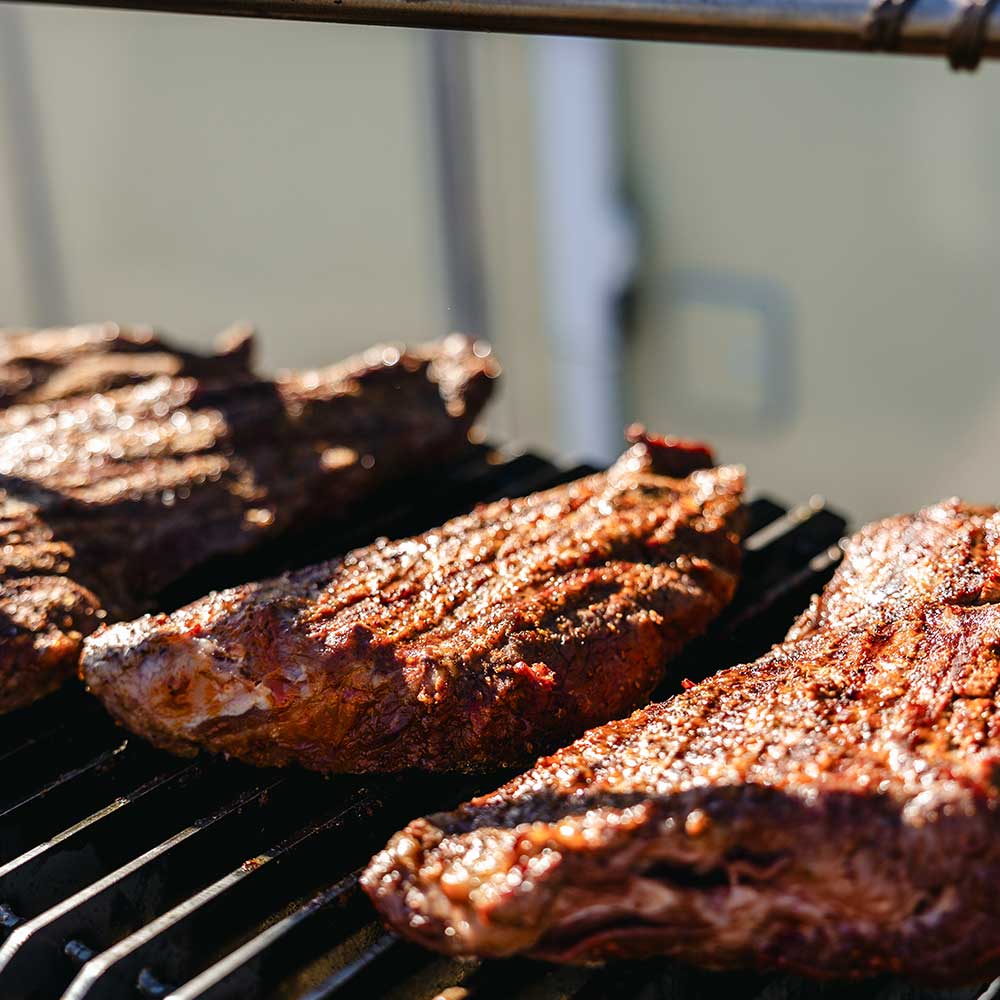 closeup of beef with money barbecue seasoning on bbq grill