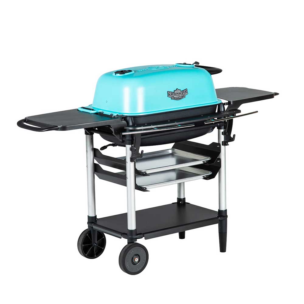 Angled front view of a PK Franklin charcoal grill with a teal lid. The grill features side shelves, two trays beneath the grilling area, and a lower shelf for additional storage. One side of the grill is supported by two wheels for easy mobility.