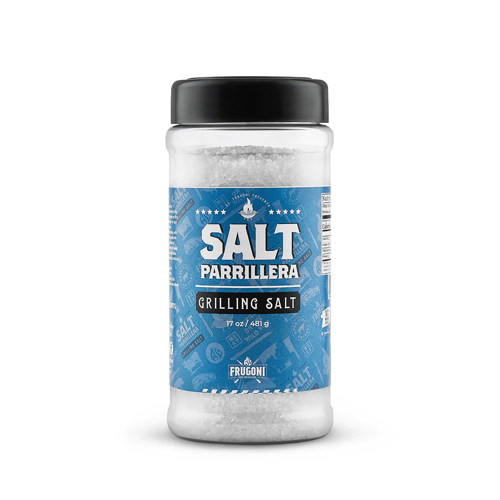 A jar of Frugoni Salt Parrillera grilling salt standing upright. The jar has a blue label with white text and contains coarse white salt.