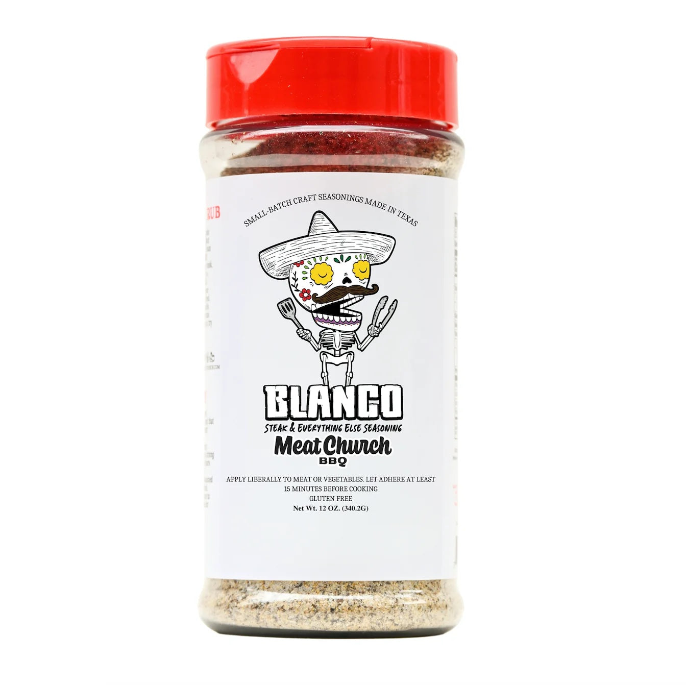 A 12-ounce jar of Meat Church Blanco Steak & Everything Else Seasoning. The label is white with black text and features a cartoon skeleton wearing a sombrero, holding grilling tools. The seasoning is a mix of coarse spices.