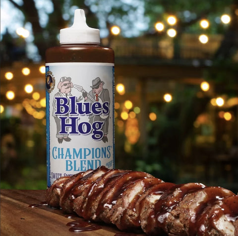 Juicy pork slathered in Blues Hog Champion's Blend BBQ Sauce, a tantalizing fusion of sweet, smoky, and zesty flavors.