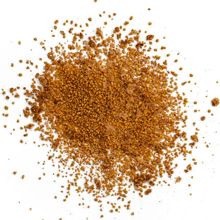 Close-up view of Simply Marvelous Sweet & Spicy Rub seasoning, showing a pile of reddish-brown granules. The texture appears to be a mix of fine and coarse particles, with visible chunks of seasoning.
