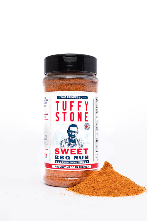 A plastic bottle of Tuffy Stone Sweet BBQ Rub with a black lid, next to a small pile of the rub on a white surface. The label shows Tuffy Stone, 'The Professor,' and the product name in red and blue text.