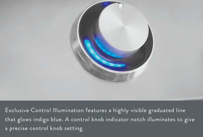 Close-up of a grill control knob with exclusive control illumination, featuring a highly visible graduated line that glows indigo blue for precise control settings.