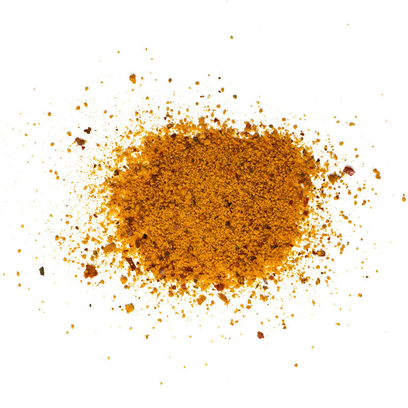 Close-up image of the 'Your Behind BBQ Chipotle Mango Rub' seasoning, showing a coarse blend of spices and herbs in shades of orange and brown.