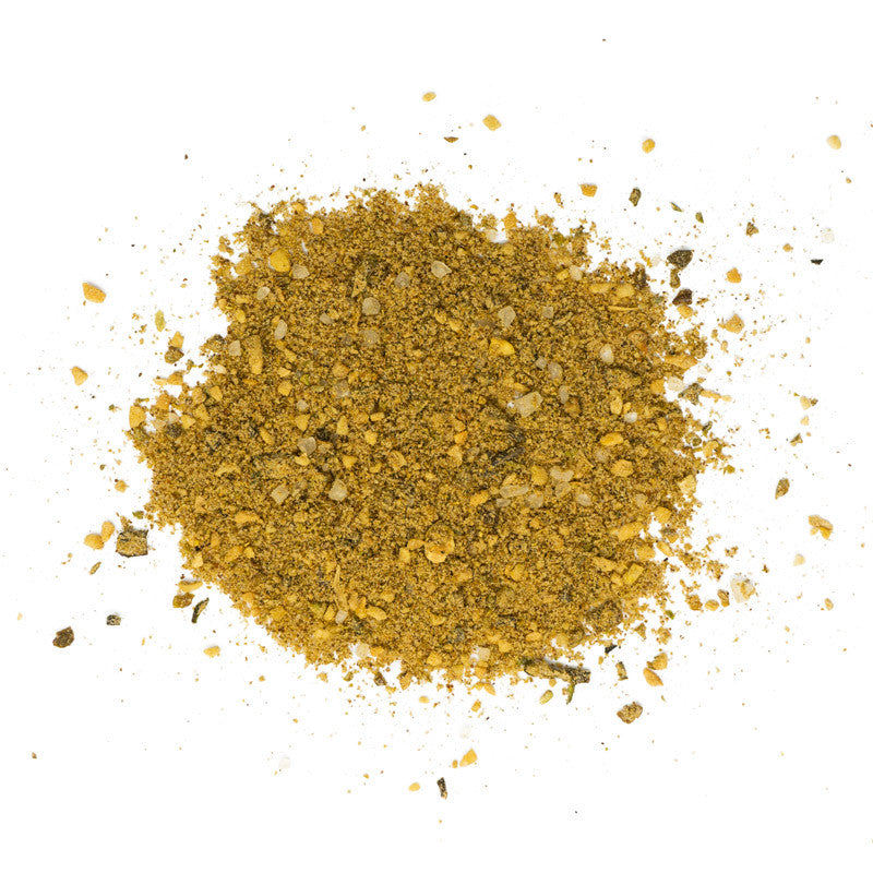 Close-up image of the 'Your Behind BBQ Green Chile Bacon Rub' seasoning, showing a coarse blend of spices and herbs in shades of green and yellow.