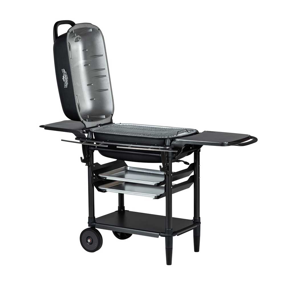 Side view of a PK Franklin charcoal grill with the lid open, revealing the grilling area. The grill features side shelves and two trays beneath the grilling area for storage.