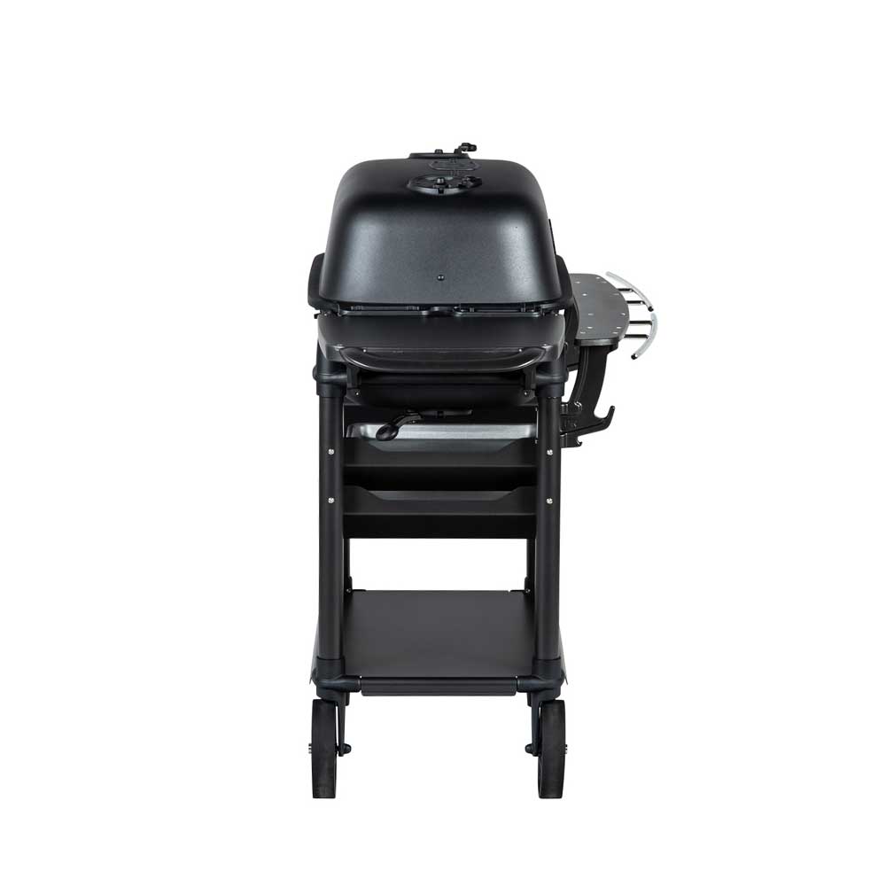 Side view of a PK Franklin charcoal grill with a black lid. The grill features a side shelf and two trays beneath the grilling area for added storage.