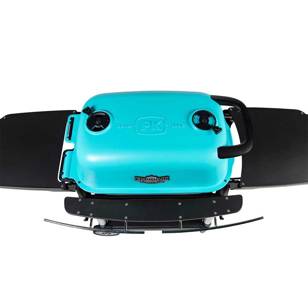 Top view of a PK Franklin charcoal grill with a teal lid, showing the brand logo and two air vents for controlling the temperature.