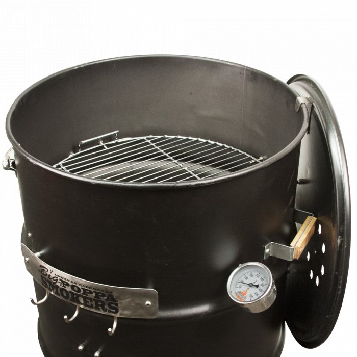 Close-up of the top section of an assembled black BPS DIY Drum Smoker featuring a thermometer and top vent, showcasing the grill cooking grate inside.