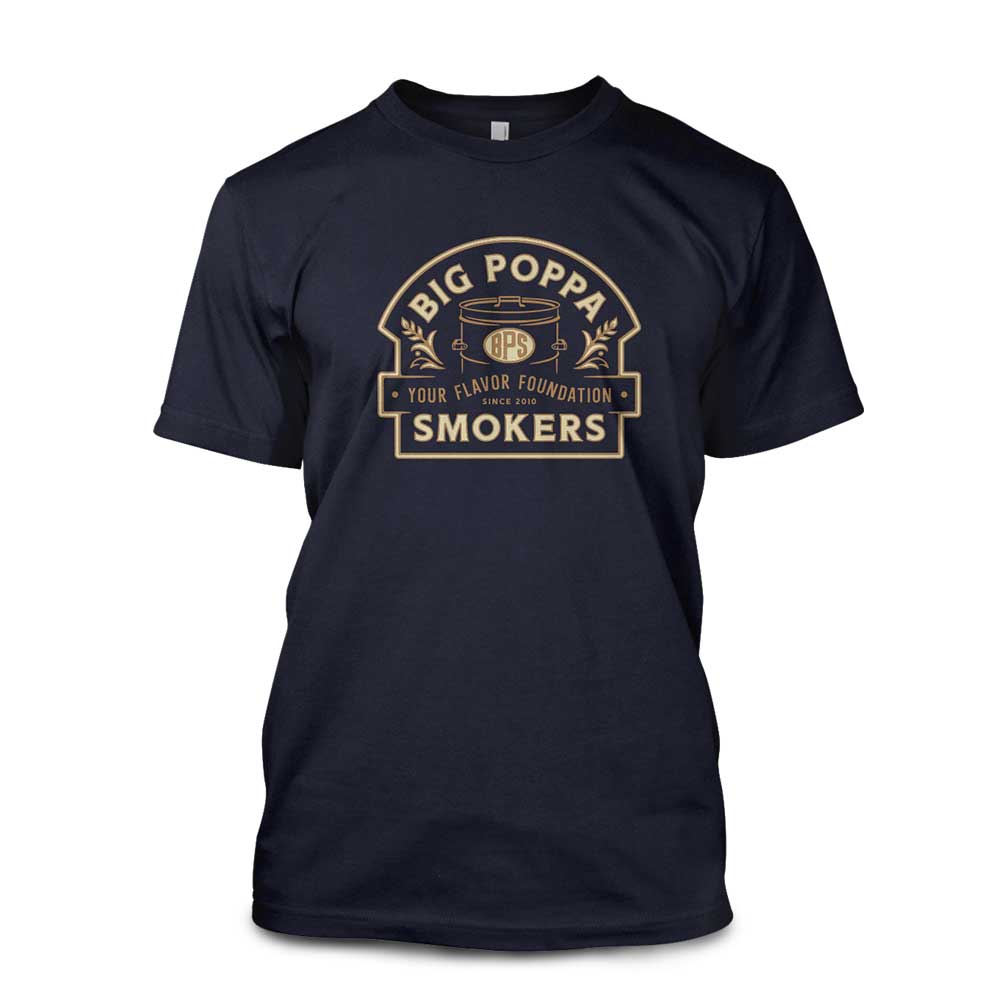 Navy T-shirt with a tan and gold design of the Big Poppa Smokers logo, highlighting a smoker graphic and the tagline "Your Flavor Foundation - Since 2010.