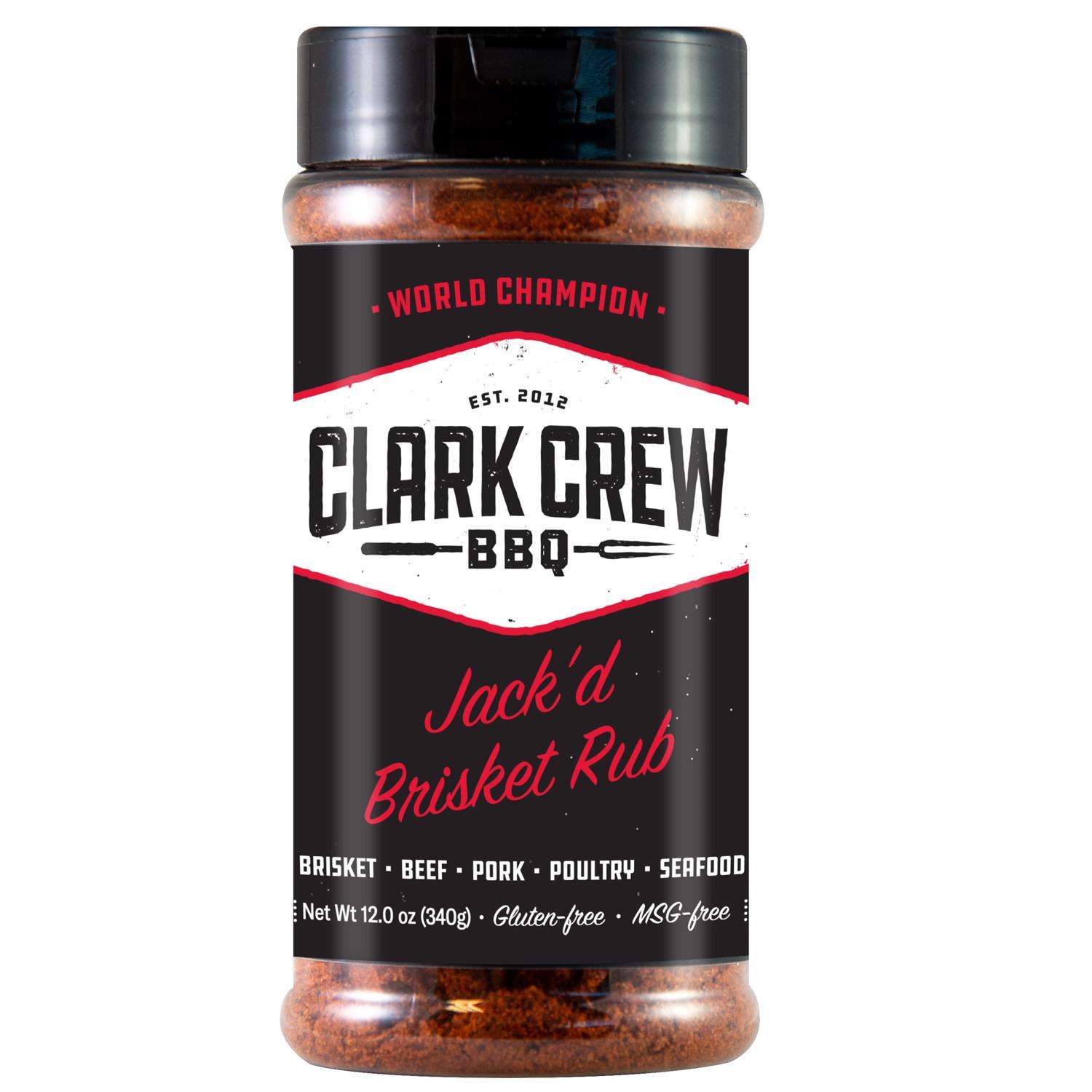 The front of a jar of Clark Crew BBQ Jack'd Brisket Rub with a black lid. The label is black with white and red accents, featuring the brand name "Clark Crew BBQ" and the product name "Jack'd Brisket Rub" along with usage suggestions for brisket, beef, pork, poultry, and seafood. The net weight is 12 ounces (340 grams).