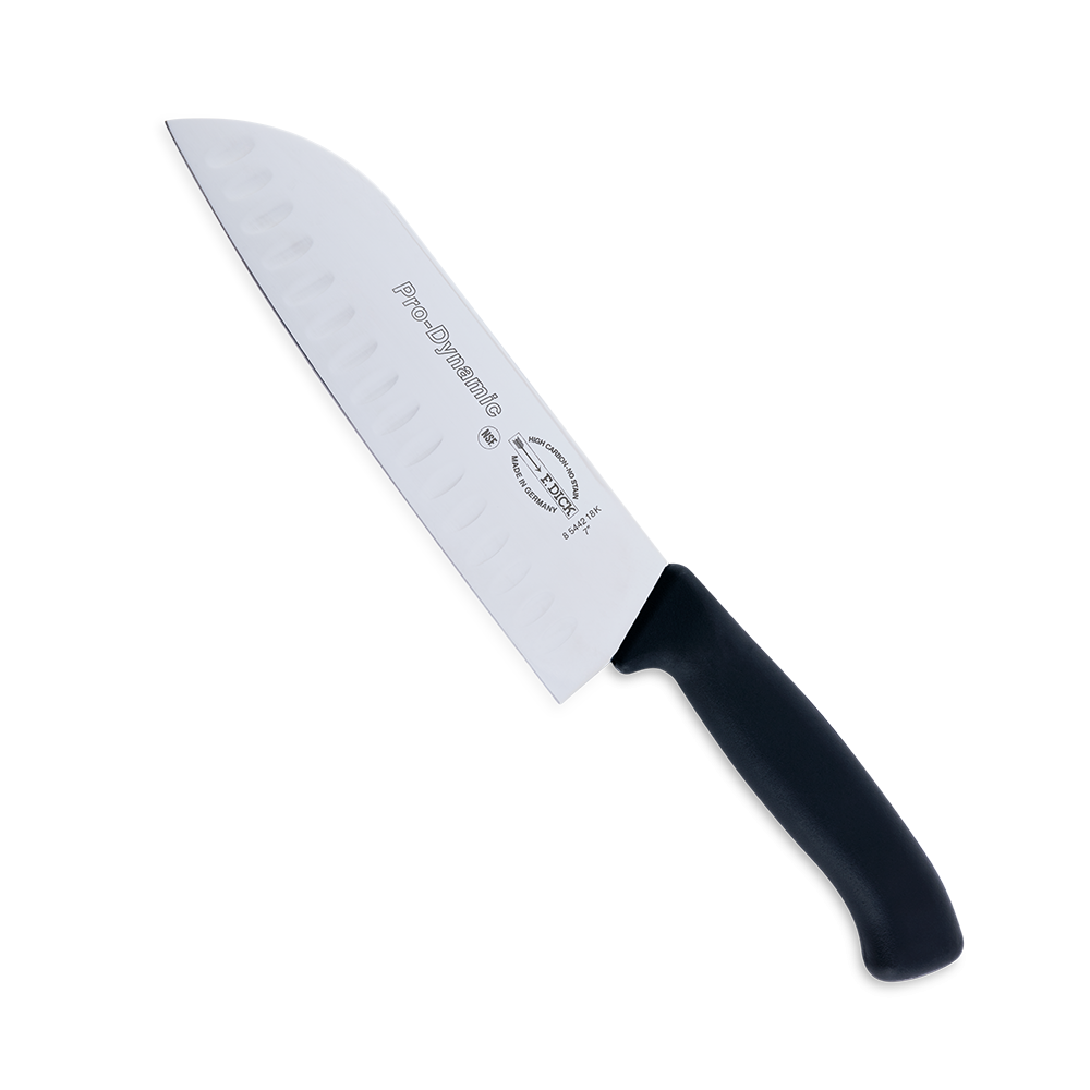 Close-up image of the F. Dick 7" Santoku Kullenschliff - ProDynamic. The knife features a high-carbon stainless steel blade with a kullenschliff edge to prevent food from sticking. It has a black ergonomic handle designed for comfort and control. Displayed on a plain white background, highlighting its sharpness and professional design.