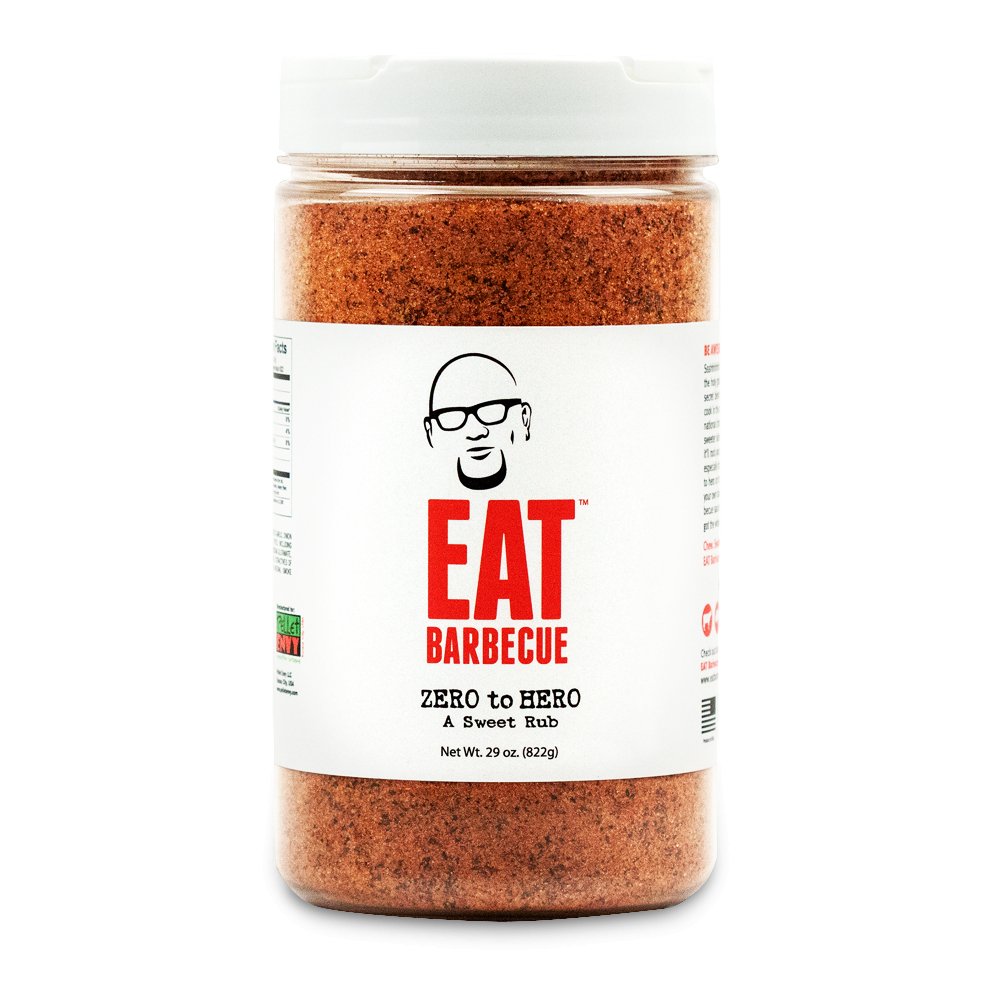 A 29-ounce container of EAT Barbecue Zero to Hero sweet rub with a white lid. The label features a stylized image of a man's face wearing glasses above the brand name "EAT Barbecue" in red text. The rub is labeled as "Zero to Hero A Sweet Rub.