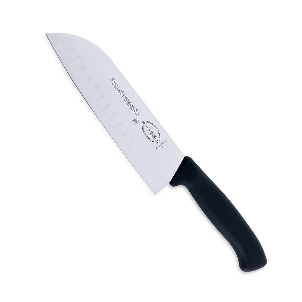 Close-up image of the F. Dick 7" Santoku Kullenschliff - ProDynamic. The knife features a high-carbon stainless steel blade with a kullenschliff edge to prevent food from sticking. It has a black ergonomic handle designed for comfort and control. Displayed on a plain white background, highlighting its sharpness and professional design.