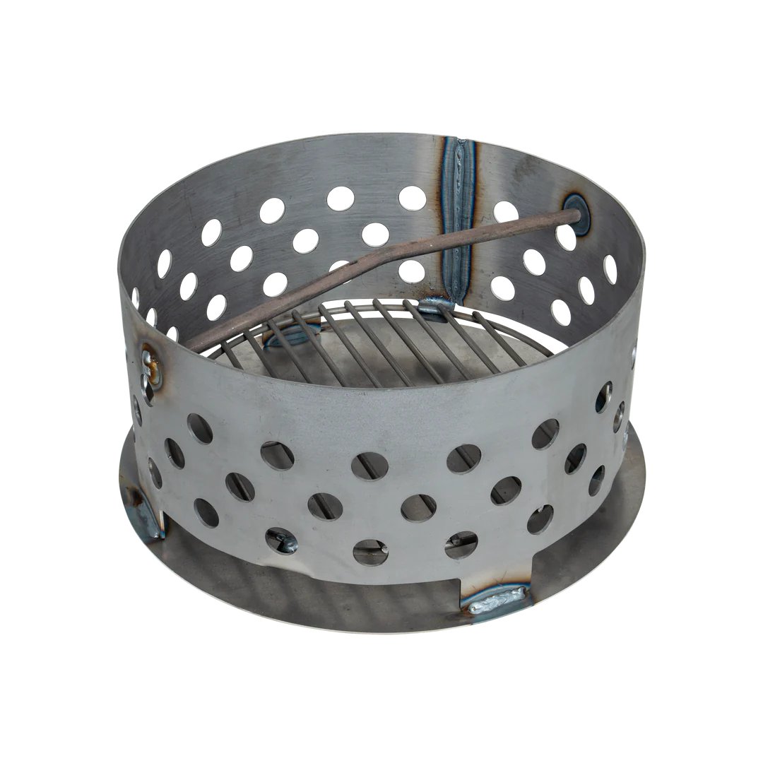 A cylindrical metal charcoal basket with multiple circular holes and a grate at the bottom, designed for use in a drum smoker to hold charcoal.