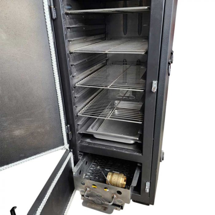 The interior of a vertical BBQ smoker with the door open, showing multiple metal racks, a drip pan, and a charcoal drawer with a brass fitting.