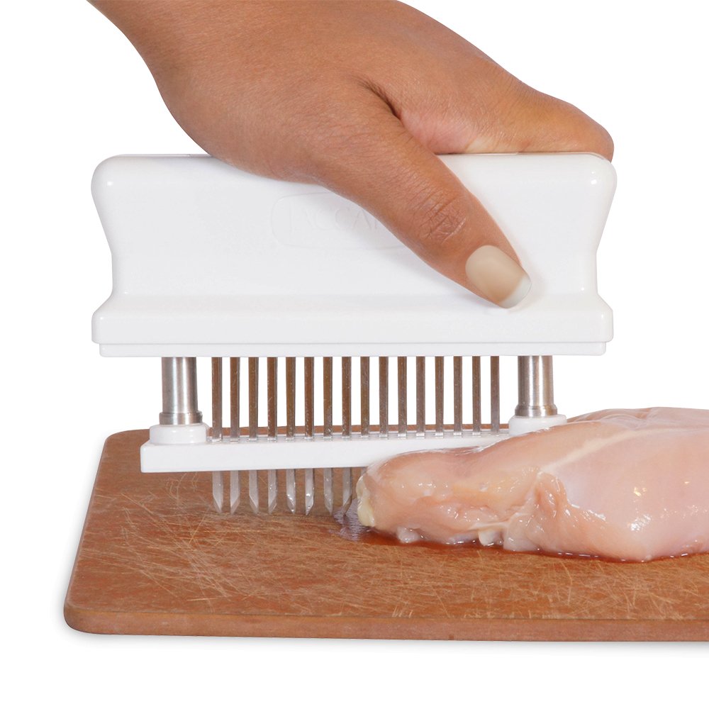 Jaccard Meat Tenderizer, handheld tool with multiple stainless steel blades for tenderizing meats for BBQ and grilling.  This is an image of showing how you tenderize a chicken breast.