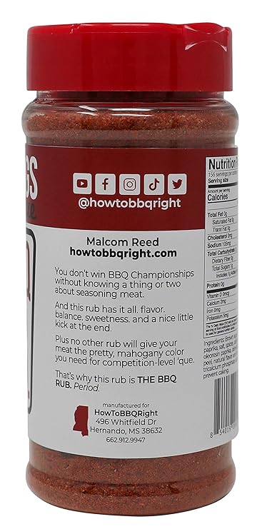 A side view of a Killer Hogs The BBQ Rub bottle showing a section of the label with social media icons and the manufacturer’s details. The bottle is filled with a red-orange spice blend and has a red cap.