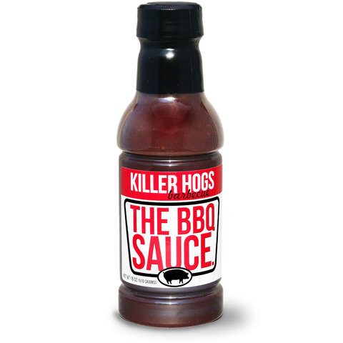 Bottle of Killer Hogs The BBQ Sauce, prominently displaying its label, ideal for adding a flavorful punch to any BBQ dish with its perfect blend of heat, sweetness, and tanginess. Great for both competitive and backyard BBQs.