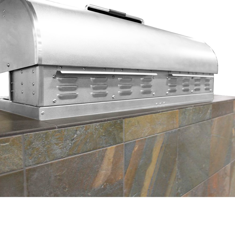 Close-up rear view of a stainless steel MAK Grills pellet smoker built into a tiled outdoor kitchen counter.