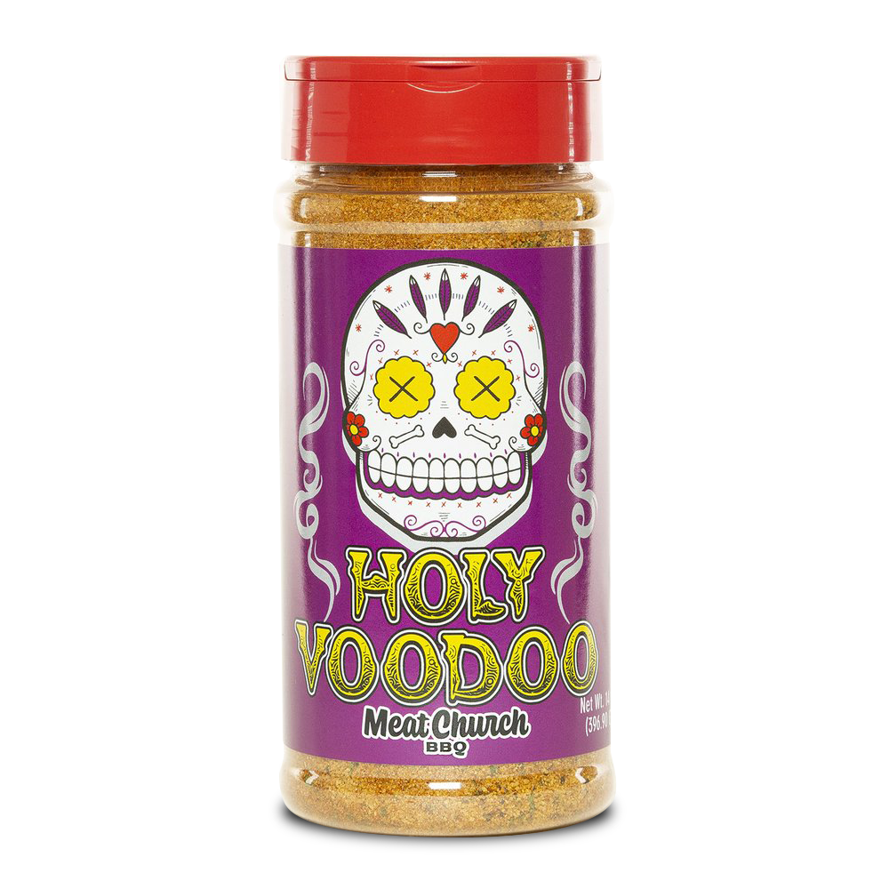 A 14-ounce jar of Meat Church Holy Voodoo Seasoning. The label is purple with yellow text and features a cartoon sugar skull with yellow eyes and a red lid. The jar contains a coarse, orange spice mix.