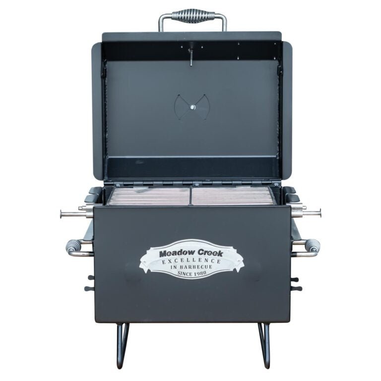 Front view of the Meadow Creek BBQ18 Chicken Cooker with the lid open, showing the stainless steel grate inside. The cooker has "Meadow Creek Excellence in Barbecue Since 1980" logo on the front.