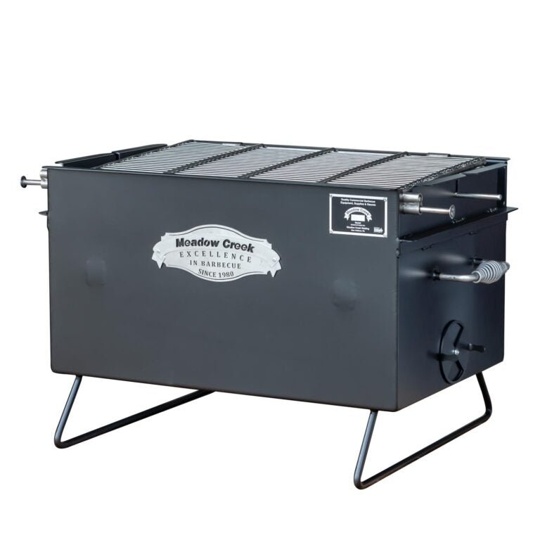 Angled view of the Meadow Creek BBQ26 Chicken Cooker, revealing the cooking grate. The cooker features a "Meadow Creek Excellence in Barbecue Since 1980" logo on the front.