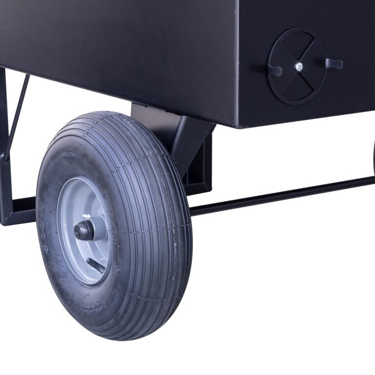 Close-up of the large wheel attached to the Meadow Creek BBQ42 Chicken Cooker. The cooker features a vent on the side for airflow control.