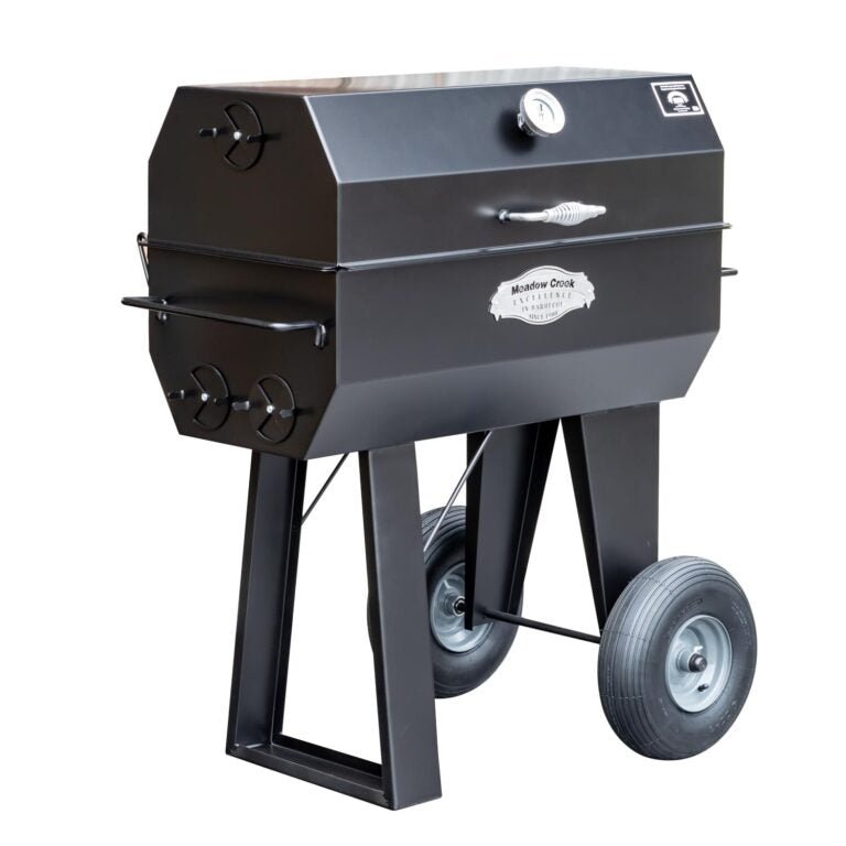 A side view of the Meadow Creek PR36 pig roaster with the lid closed, displaying the sleek black exterior and sturdy construction.