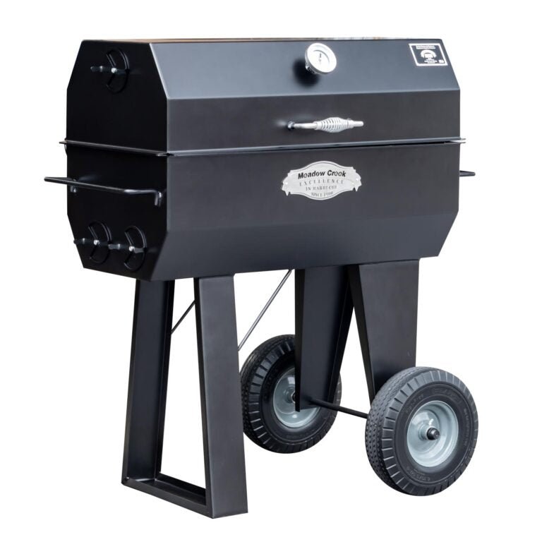 A side view of the Meadow Creek PR36 pig roaster with the lid closed, displaying the sleek black exterior and sturdy construction.