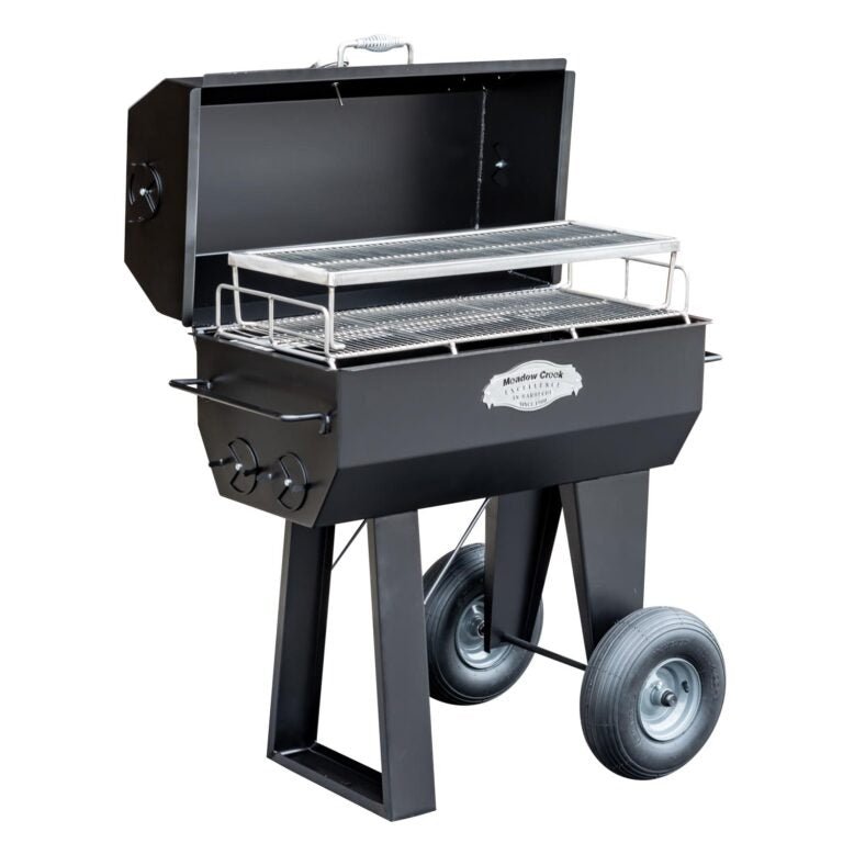 An angled view of the Meadow Creek PR36 pig roaster, showing the double-tier grilling racks and the large wheels for easy mobility.