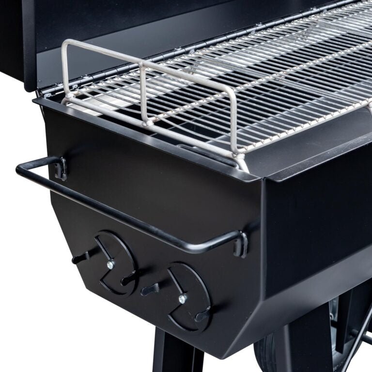 A detailed view of the grilling surface on the Meadow Creek PR36 pig roaster, showcasing the stainless steel grates and side handles.