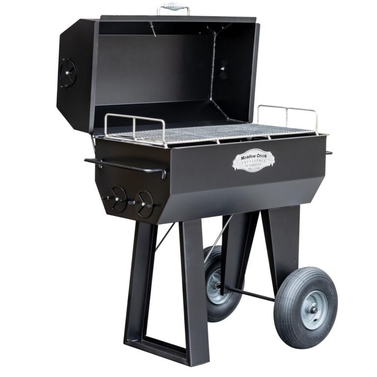 An angled view of the Meadow Creek PR36 pig roaster, showing the grilling rack and the large wheels for easy mobility.