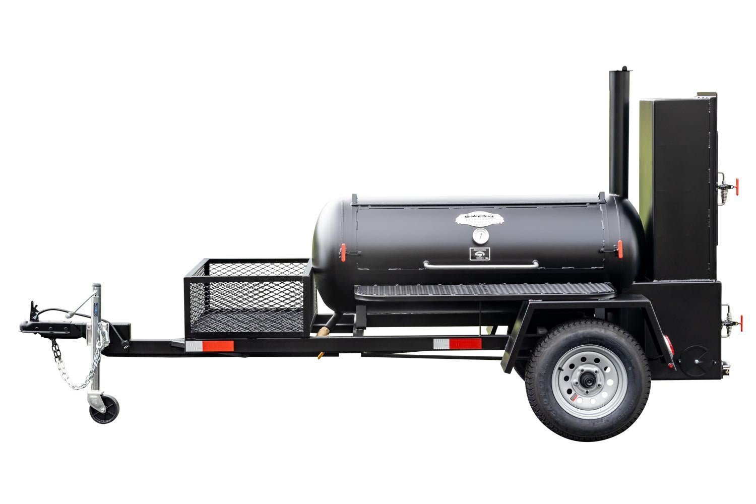 Full view of a Meadow Creek BBQ smoker trailer with a closed smoking chamber and a front utility basket, mounted on a sturdy black frame.