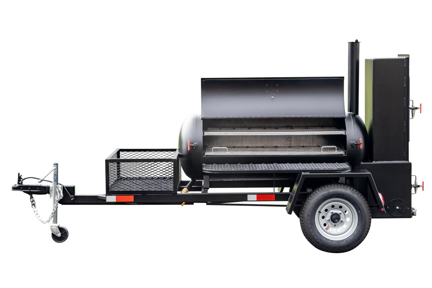 Close-up view of the warming box and firebox of a Meadow Creek BBQ smoker trailer, with open doors and visible shelves inside.