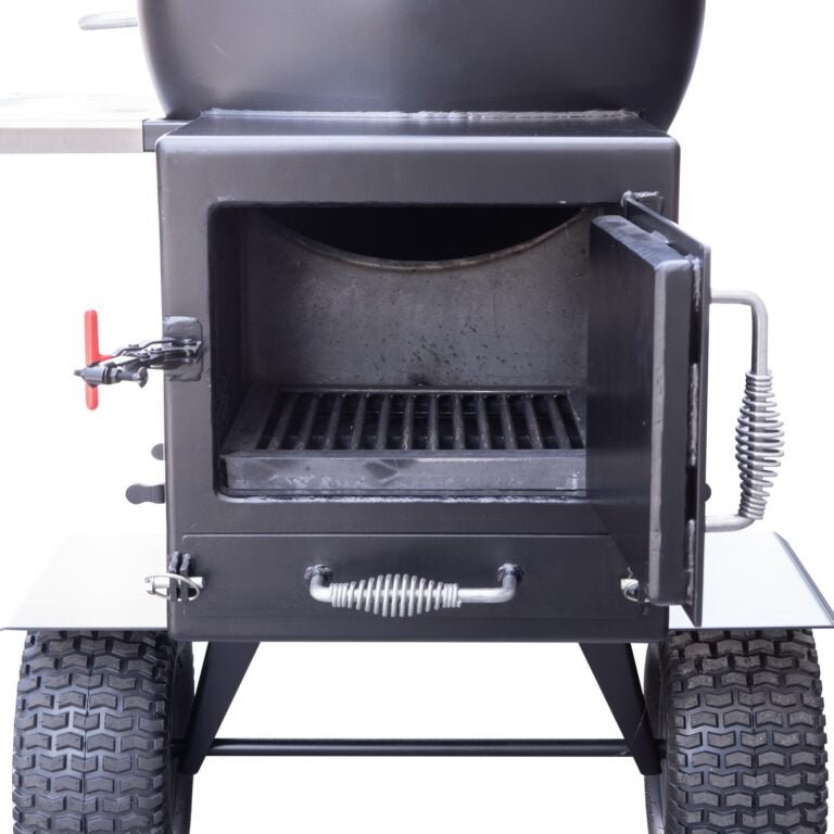 Close-up of the insulated firebox door on a BBQ smoker, showing the heavy-duty construction and hinge details.