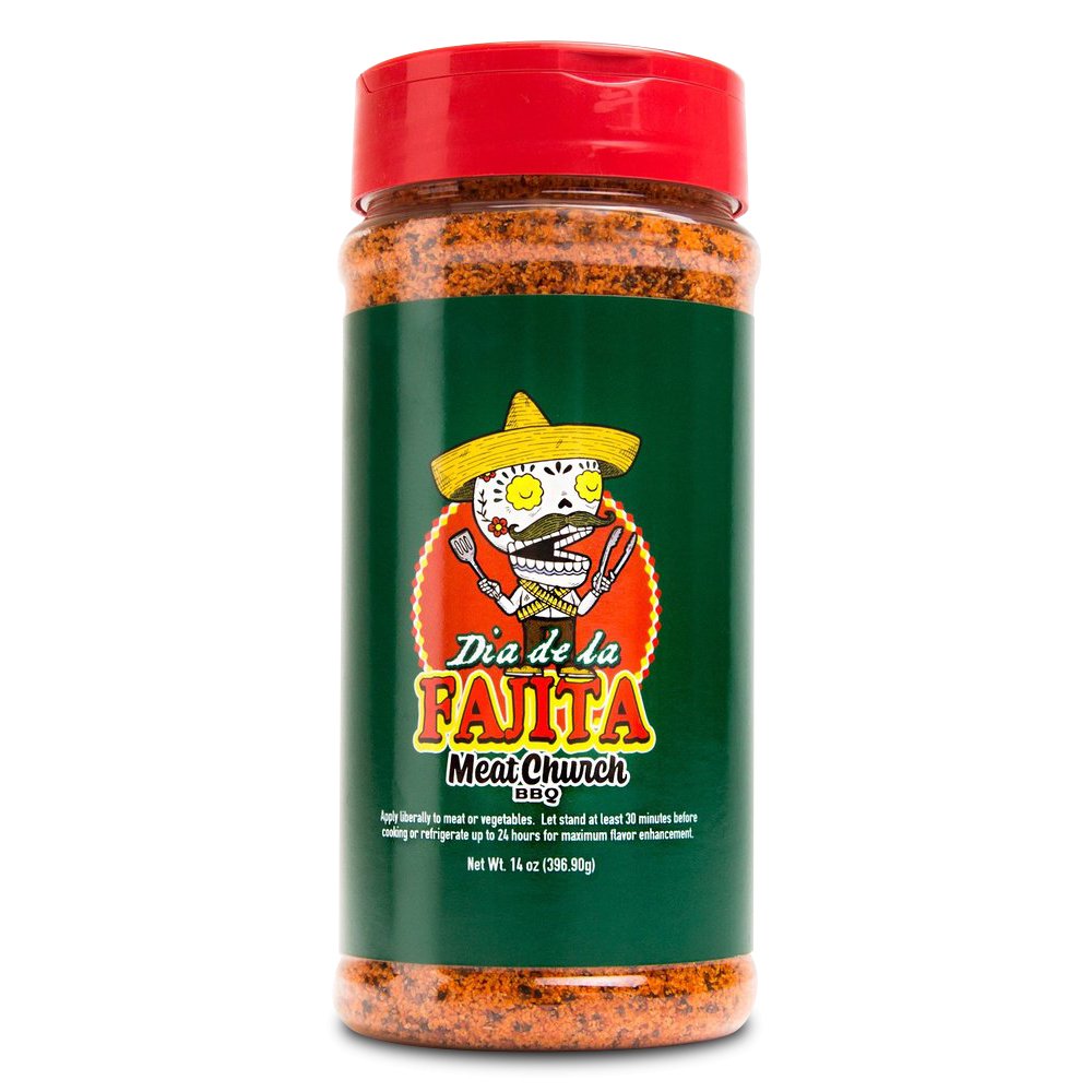 A 14-ounce jar of Meat Church Dia de la Fajita Seasoning. The label is green with red and yellow text and features a cartoon skeleton wearing a sombrero, holding grilling tools. The jar has a red lid and contains a coarse, reddish-brown spice mix.