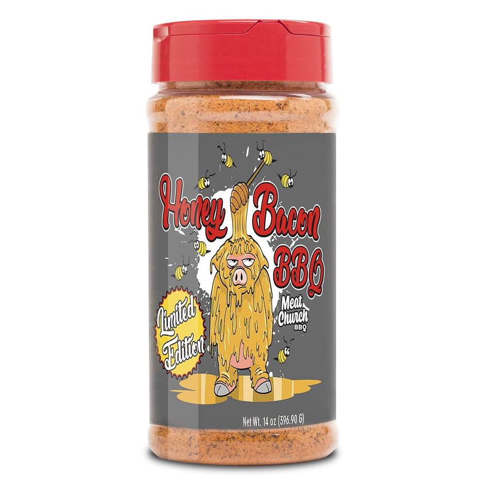 A 14-ounce jar of Meat Church Honey Bacon BBQ Rub. The label is gray with red text and features a cartoon pig covered in honey, holding a honey dipper, with bees flying around. The jar has a red lid and contains a coarse, reddish-brown spice mix. The label also indicates it is a limited edition.